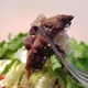 Close-up of a forkful of Chipotle brisket, with some bark visible on the exterior